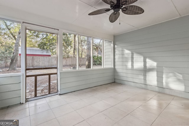 unfurnished sunroom featuring ceiling fan