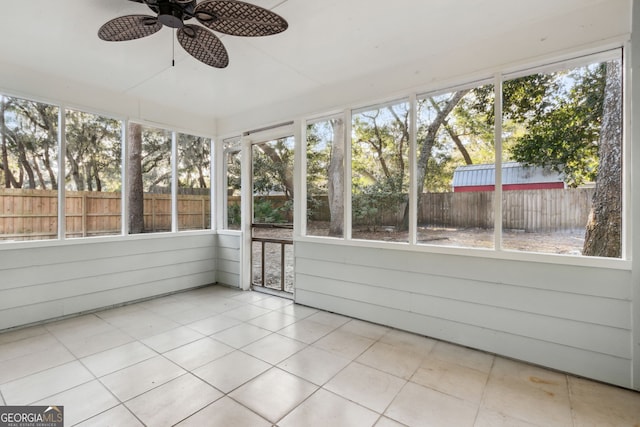 unfurnished sunroom with ceiling fan