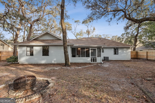 back of house featuring central AC and an outdoor fire pit