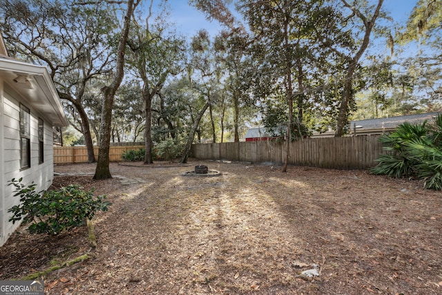 view of yard with an outdoor fire pit