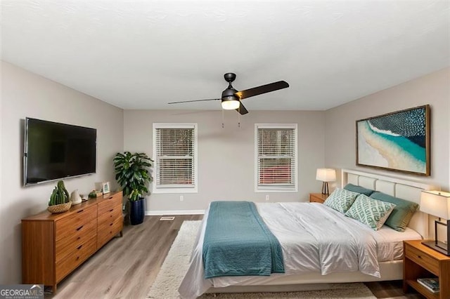 bedroom featuring ceiling fan and light hardwood / wood-style flooring