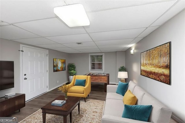 living room featuring hardwood / wood-style flooring and a paneled ceiling