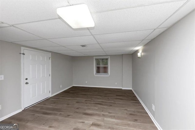 basement featuring hardwood / wood-style floors and a drop ceiling