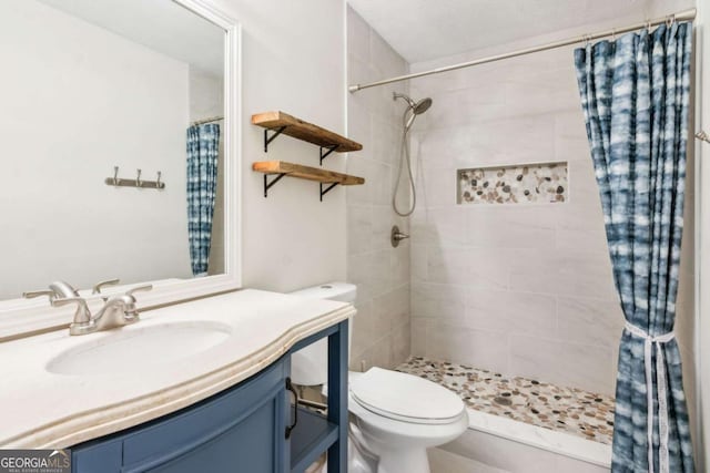 bathroom with vanity, toilet, and a shower with shower curtain