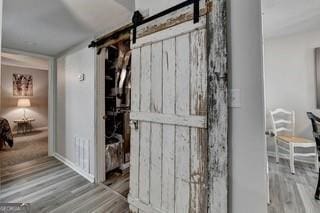 interior space featuring a barn door and hardwood / wood-style floors