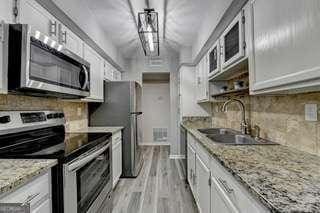 kitchen featuring white cabinetry, sink, tasteful backsplash, and stainless steel appliances