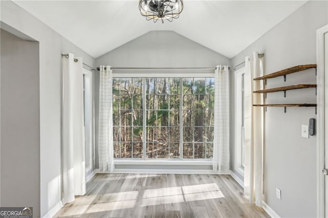 interior space with vaulted ceiling and light wood-type flooring