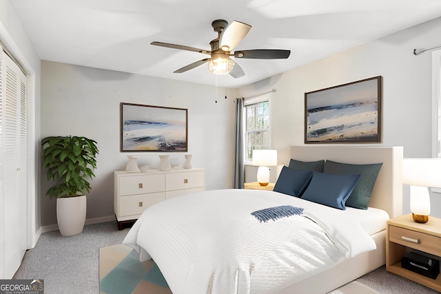 carpeted bedroom featuring ceiling fan and a closet