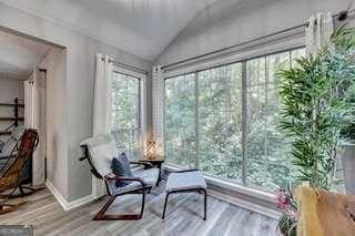 sunroom / solarium featuring vaulted ceiling