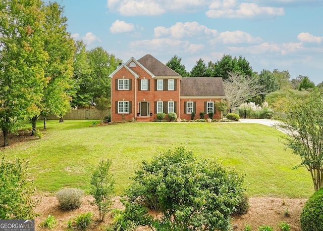 colonial-style house with a front lawn