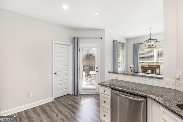 kitchen with dishwasher, dark stone countertops, white cabinets, hanging light fixtures, and a healthy amount of sunlight