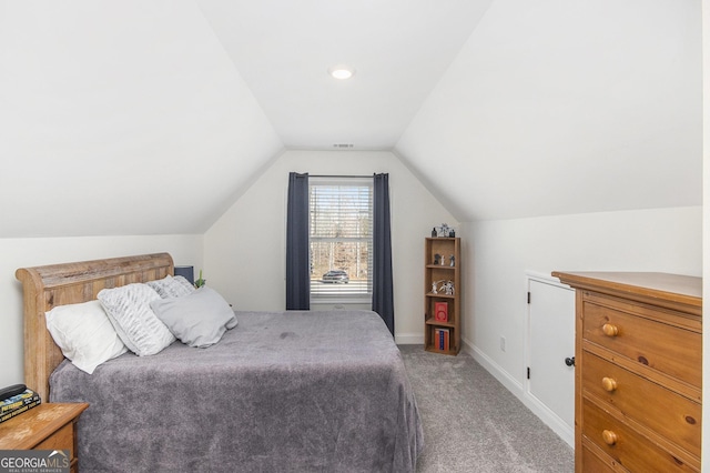 carpeted bedroom with lofted ceiling