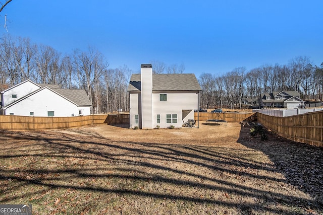 back of house with a lawn