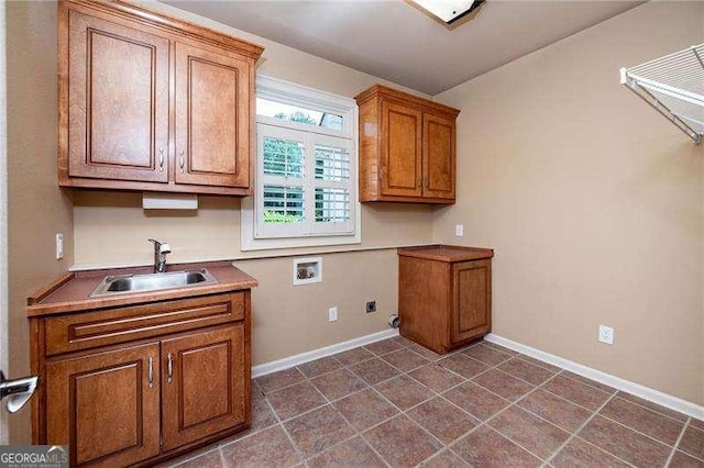 washroom with washer hookup, sink, cabinets, and electric dryer hookup