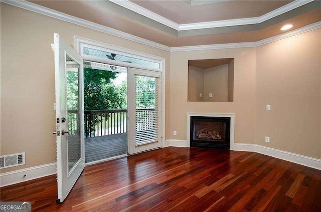 doorway to outside featuring crown molding, dark wood-type flooring, and a tray ceiling