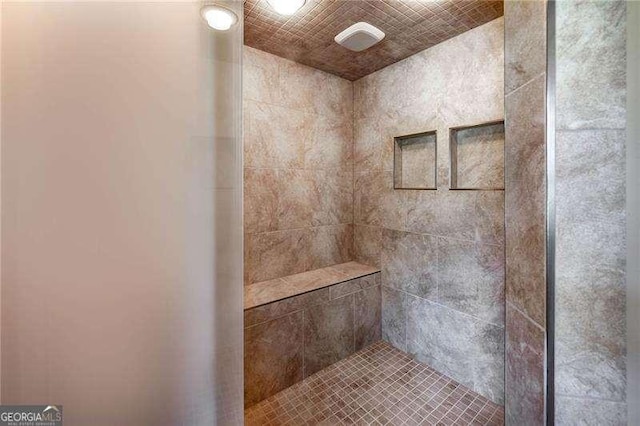 bathroom with a tile shower