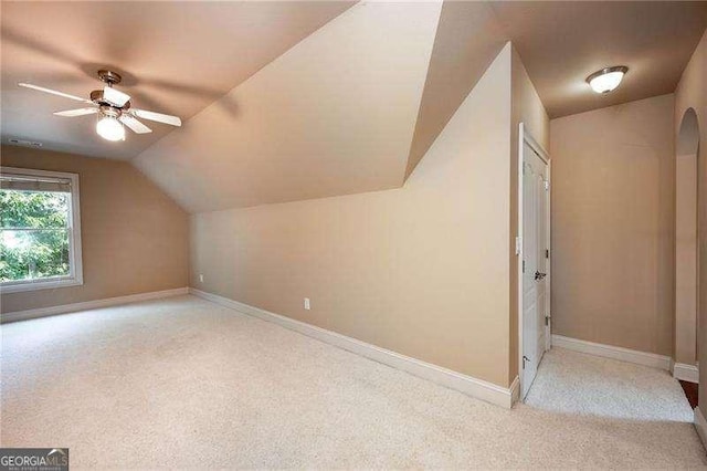 additional living space with ceiling fan, lofted ceiling, and light carpet