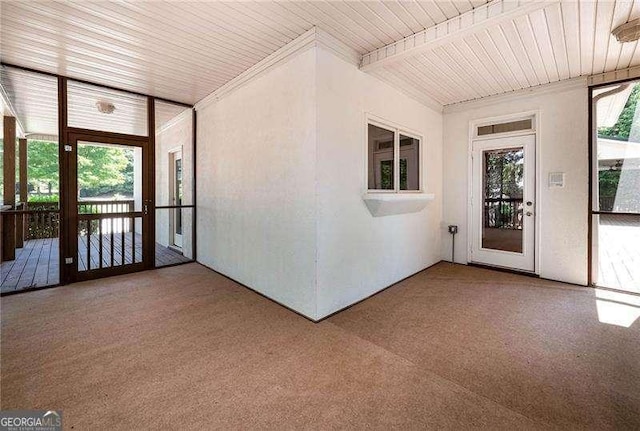 unfurnished sunroom with wood ceiling