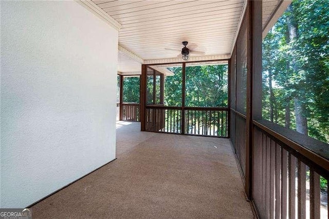 unfurnished sunroom with ceiling fan