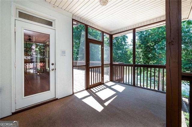 unfurnished sunroom featuring wooden ceiling