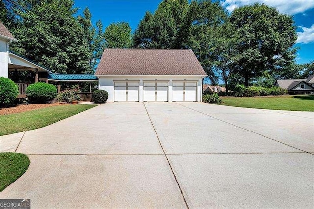 view of side of home with a garage and a lawn