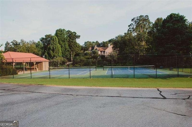 view of sport court with a yard