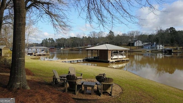 dock area featuring a water view and a lawn