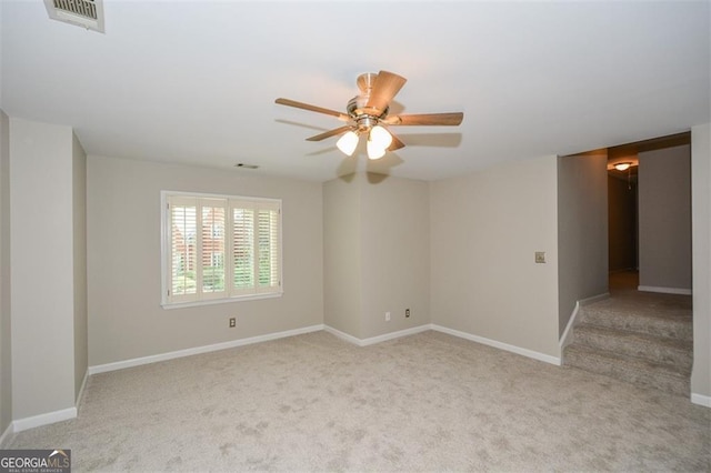 spare room with light colored carpet and ceiling fan