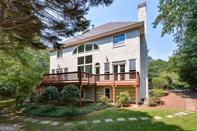 back of house with a deck and a lawn