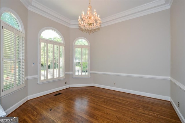 unfurnished room featuring ornamental molding, dark hardwood / wood-style floors, and a chandelier