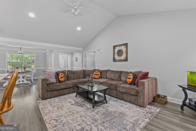 living room featuring hardwood / wood-style floors, high vaulted ceiling, and ceiling fan