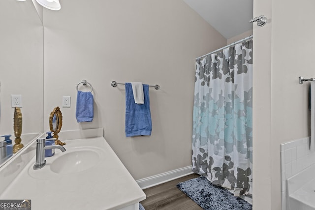 bathroom featuring hardwood / wood-style flooring, vanity, and a shower with shower curtain