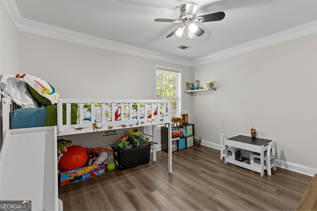 bedroom with ornamental molding, hardwood / wood-style floors, and ceiling fan