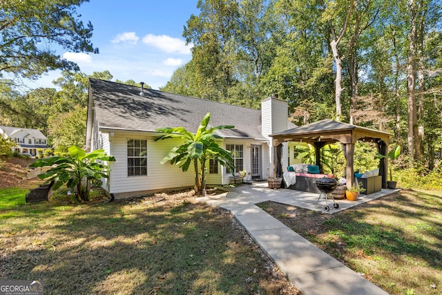 view of front of home featuring a gazebo, a front yard, and a patio