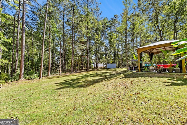 view of yard with a gazebo and a storage unit