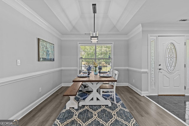 dining area with dark wood-type flooring, crown molding, and vaulted ceiling