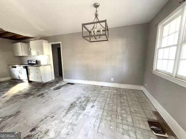 unfurnished dining area with an inviting chandelier