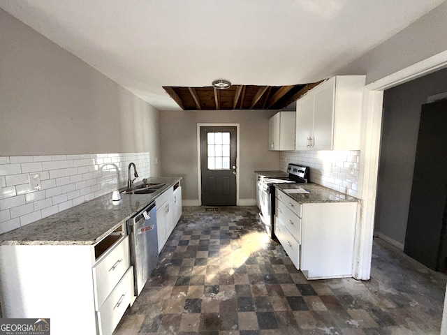 kitchen with appliances with stainless steel finishes, sink, white cabinets, backsplash, and dark stone counters