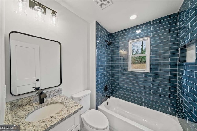 full bathroom with vanity, toilet, and tiled shower / bath combo