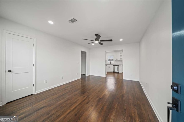 unfurnished living room featuring ceiling fan and dark hardwood / wood-style flooring