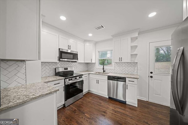 kitchen featuring dark wood-type flooring, sink, white cabinetry, light stone counters, and stainless steel appliances