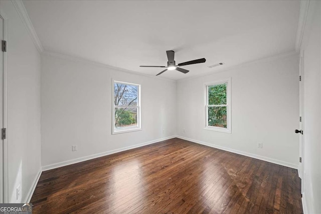 spare room featuring dark wood-type flooring, ceiling fan, and ornamental molding