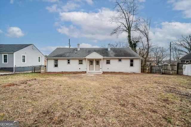 back of house featuring a lawn