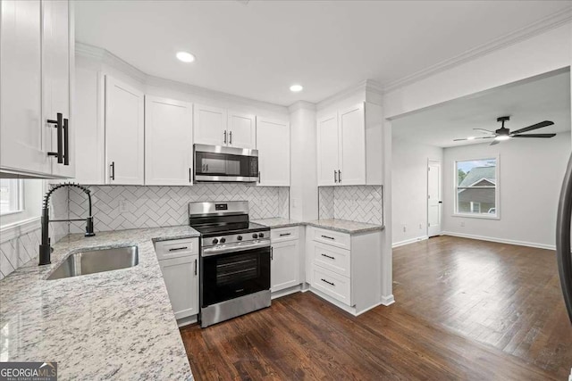 kitchen featuring white cabinetry, sink, light stone countertops, and appliances with stainless steel finishes