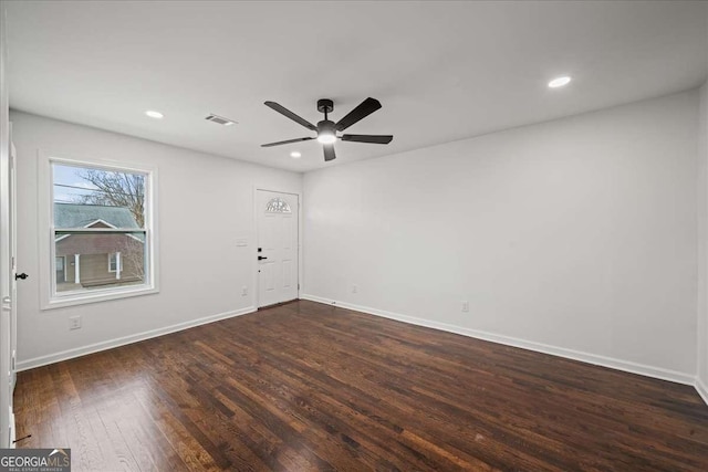 empty room with dark hardwood / wood-style flooring and ceiling fan