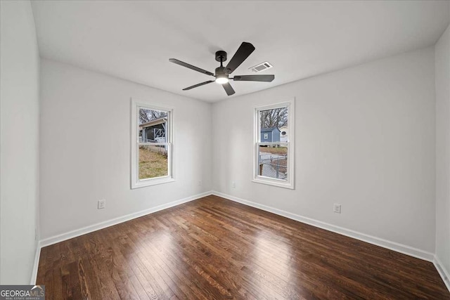 spare room featuring ceiling fan and dark hardwood / wood-style floors