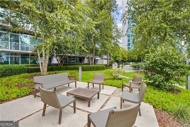 view of property's community with outdoor lounge area and a patio area