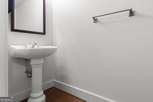 bathroom with hardwood / wood-style floors