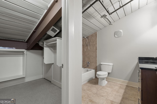 full bathroom featuring tiled shower / bath, vanity, and toilet