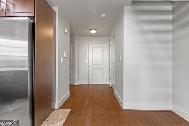 hallway with hardwood / wood-style floors